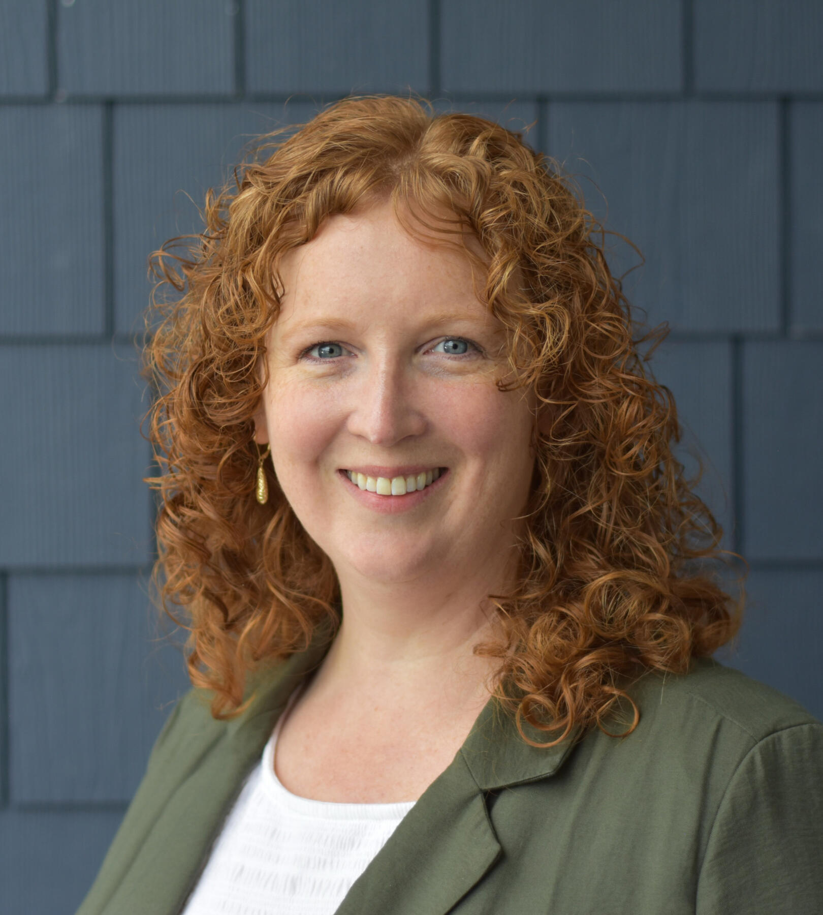 portrait of Katherine Hala wearing a green blazer